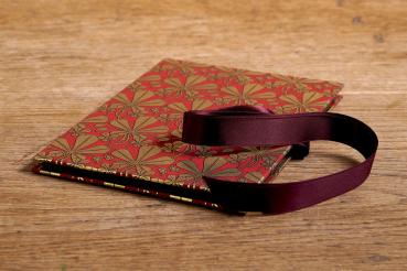 Red mini photo album with gold maple leaves and red satin bow